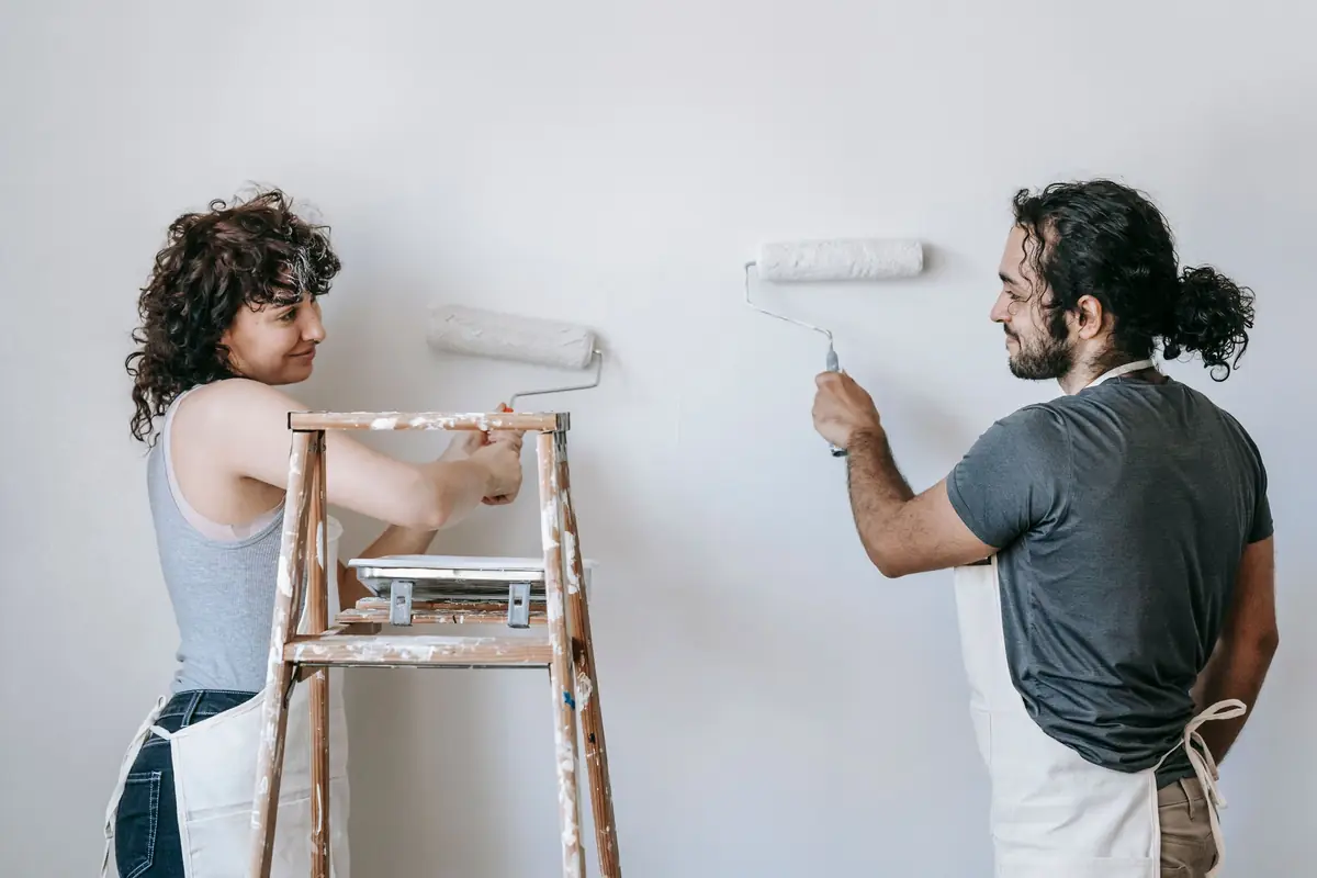 People painting a wall together — painting help in New Haven