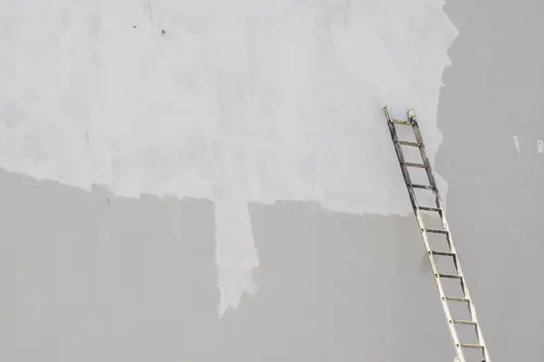 Exterior painting in New Haven: ladder against a freshly primed wall